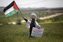 a_palestinian_woman_waves_her_national_flag_during_an_event_marking_land_day_near_the_israel-gaza_border_afp_march_30_2020